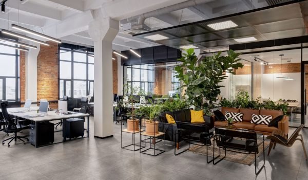 modern loft office interior with panoramic windows and a row of dark wood tables